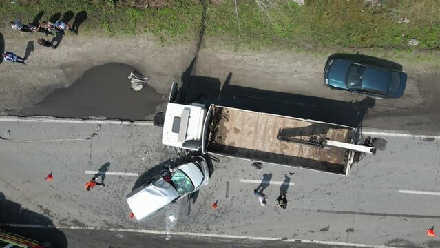 The truck and the car collided on the highway. Strong accident. Traffic accidents on the road. View from above. Traffic jam on the road