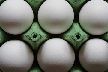 Cardboard Egg Box with six white eggs, Macro photo with shallow depth of field.