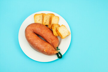 typical portuguese smoked sausage with toasts on dish