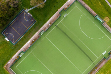 Aerial view directly above an outdoor hockey pitch and basketball court