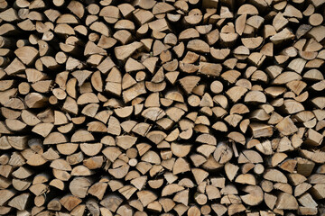 Gray and brown chopped stacked firewood background Natural eco texture