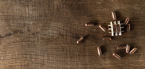 Bullets on wooden boards, table texture, top view