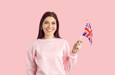 Portrait of happy smiling young woman with flag of UK. Pretty British girl with cheerful face...