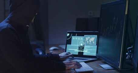 Hacker does digital machinations on online stock exchange in office side view. Cyber criminal attacks global companies financial actives - Powered by Adobe
