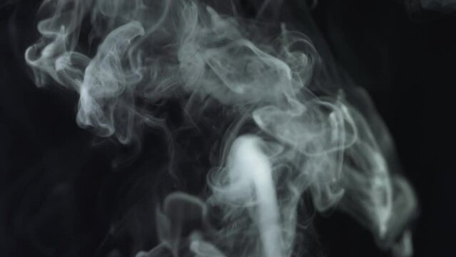 Movement of thick smoke on a black background
