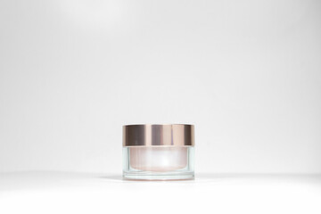 A mock up jar of cream isolated on a white gray background, on a white table with hard shadows....