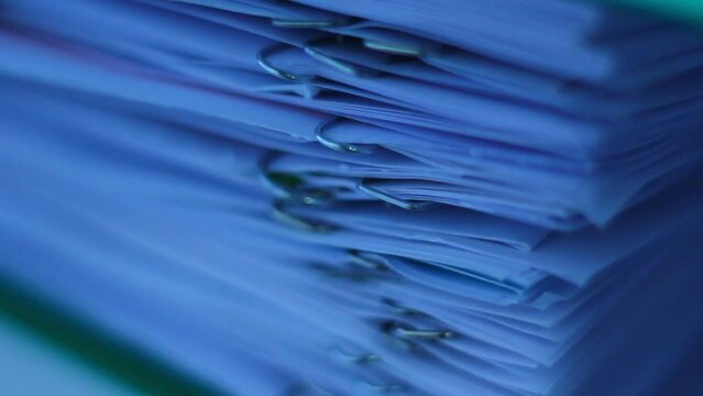 A stack of documents, papers, files. With staples. Macro clip.