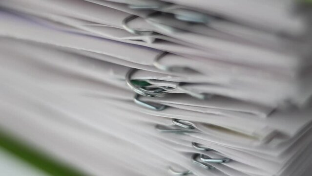 A stack of documents, papers, files. With staples. Macro clip.