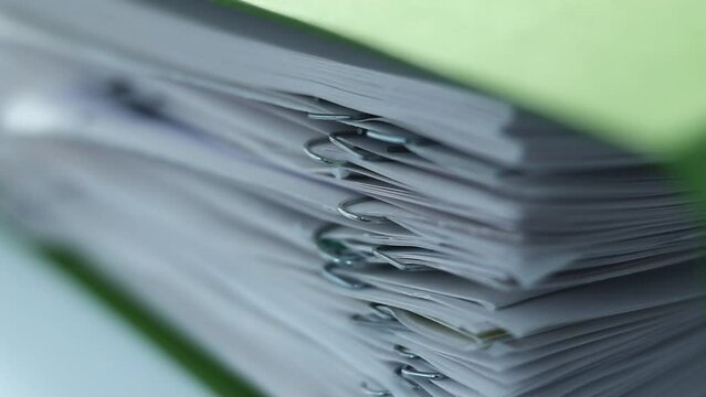A stack of documents, papers, files. With staples. Macro clip.