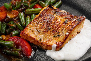 Closeup on grilled salmon steak with vegetables