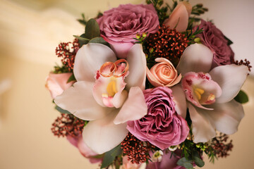 wedding rings on a bouquet of roses