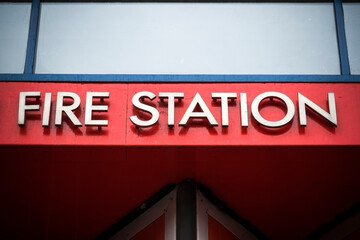 Fototapeta premium Fire station metal sign against bright red background