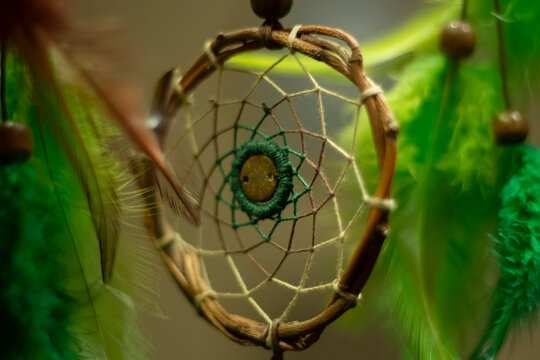 Dreamcatcher in interior. Details of Indian amulet for good sleep. Object woven from threads. Symbol of peace in house.