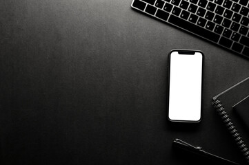Hipster black office table background with copy space and smartphone mockup.