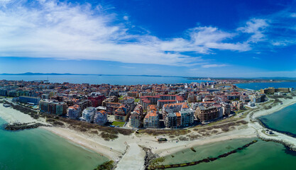 Obraz premium Panoramic view from a height above the town of Pomorie with houses and streets washed by the Black Sea in Bulgaria