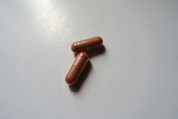 Macro of two pink capsules of PQQ dietary supplement