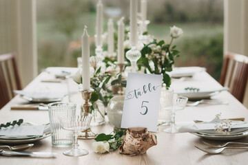Wedding or party table decorations. Dining table set up in romantic rustic vintage style. Landscape shot of wedding or party meal table decorations and set up.