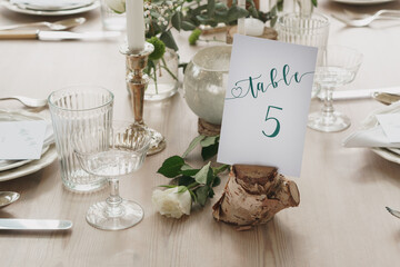 Wedding or party table decorations. Dining table set up in romantic rustic vintage style. Landscape shot of wedding or party meal table decorations and set up.