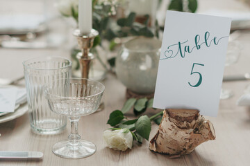 Wedding or party table decorations. Dining table set up in romantic rustic vintage style. Landscape shot of wedding or party meal table decorations and set up.