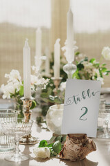 Wedding or party table decorations. Dining table set up in romantic rustic vintage style. Portrait shot of wedding breakfast set up.