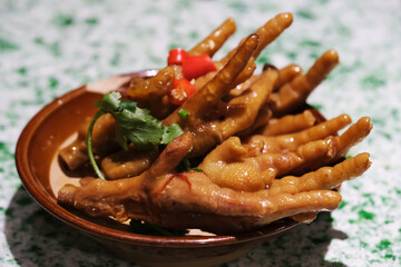 close up marinated chicken feet in plate. Traditional Chinese snack
