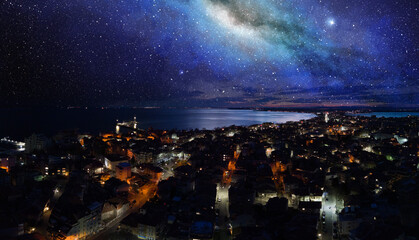 Naklejka na ściany i meble Panorama of the city of Pomorie with hotels and lights washed by the Black Sea under the starry sky in Bulgaria
