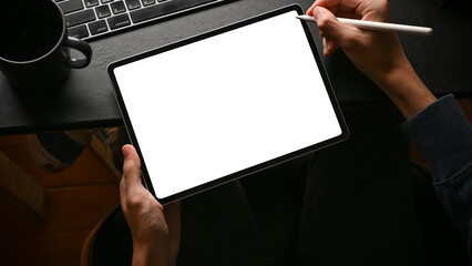 A man using digital tablet touchpad at his modern office desk.