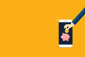Donate, donation concept. Human hand with gold coin and piggy bank on mobile phone.