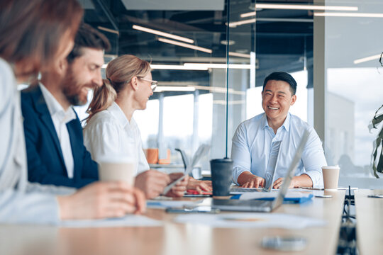 Workteam of young asian businessman working and communicating together in an modern office.