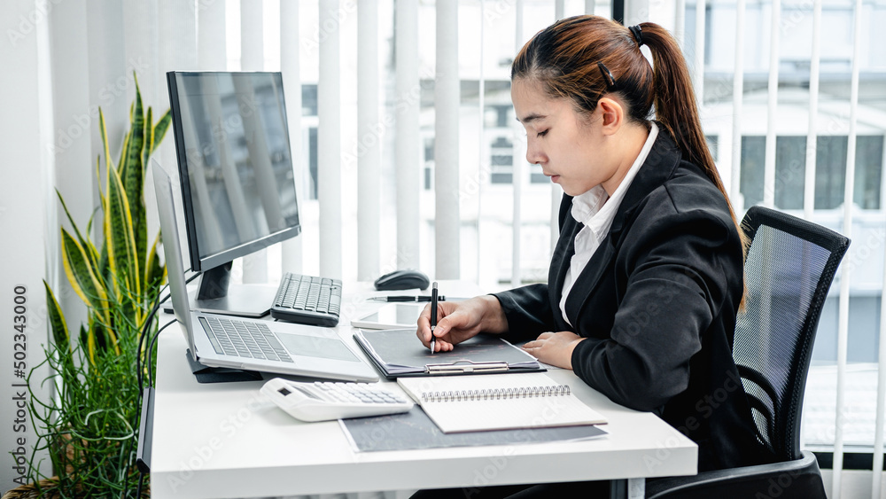 Poster Businesswoman is taking note in stock data chart on document and checking data of stock exchange trading