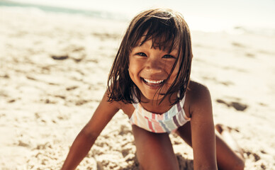 Cute young girl having a good time at the beach