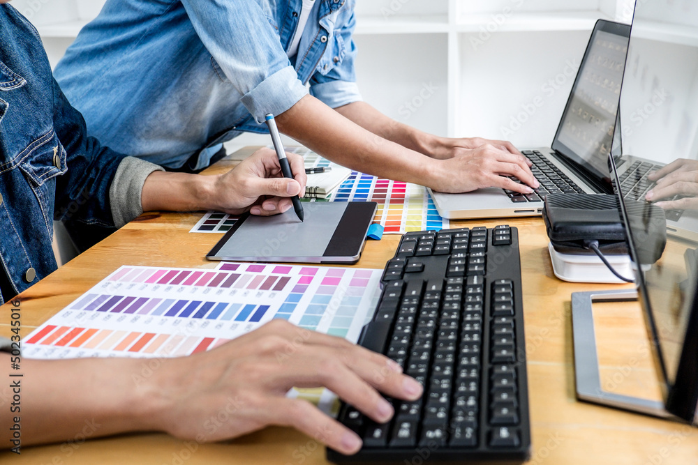 Fototapete two colleagues creative graphic designer working on color selection and drawing on graphics tablet a
