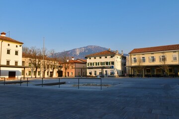Ajdovščina, Slovenia - March 27 2022: Center square in Ajdovsica town in Primorska, Slovenia and a mountain behind