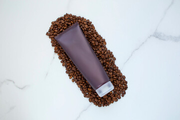 A bottle of shower gel or shampoo, bath accessories and coffee beans on a light background. The concept of beauty and health.