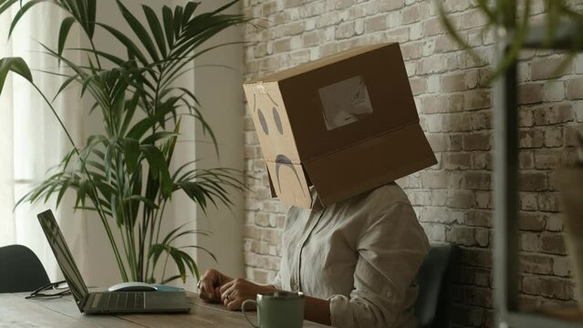 Internet computer security concept with worried carton box on the head. People working on laptop with password and vpn anonymous problems. White collar worker writing on wen page in technology leisure
