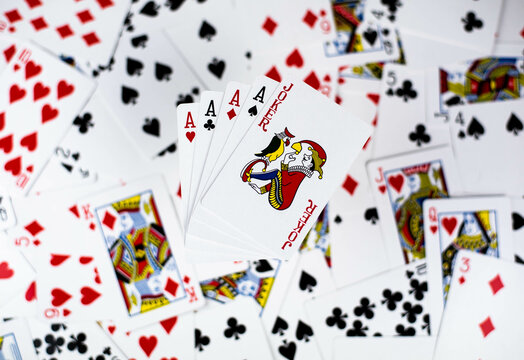 Four aces and joker on cards background