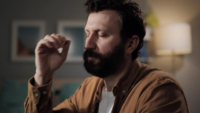 Headache, head pain. Overworked bearded man in glasses with headache. Sad tired middle aged computer user with migraine and head pain