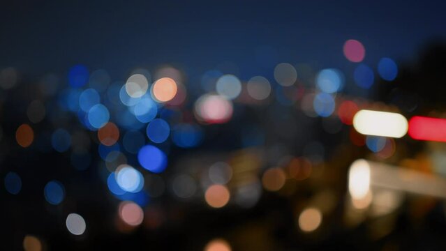 Blurred footage of cityscape at night with bokeh abstract background,Background concept