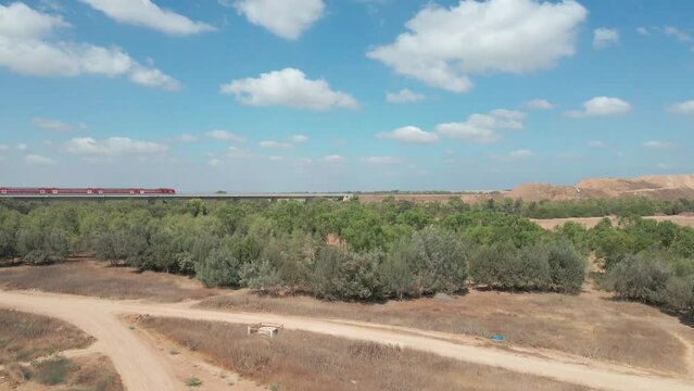 Train Crosses Green Field At Southern District City Netivot, Israel