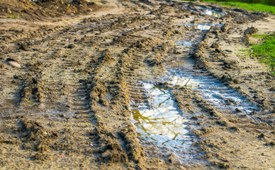 tire tracks in the mud, puddles after rain