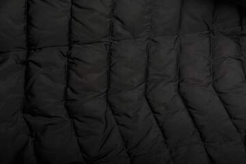 stitched down jacket or quilted outer garments black fabric texture background