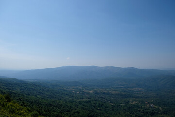 Obraz premium view of the hill and green forest in the valley 