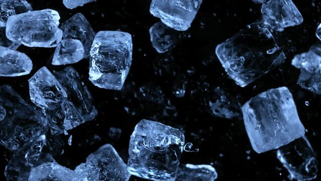 Super slow motion of falling ice cubes separated on black background. Filmed on high speed cinema camera, 1000 fps.