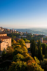 Fototapeta na wymiar Perugia old skyline at sunset with medieval churches and towers and Umbria countryside with mist just before sunset