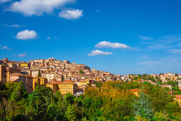 Fototapeta na wymiar View of Perugia medieval historic center with blue sky and white clouds