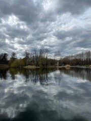 Fototapeta na wymiar Sky and trees reflection on the lake surface