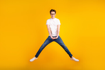Fototapeta na wymiar Full size photo of young man have fun jump up active energetic fly isolated over yellow color background