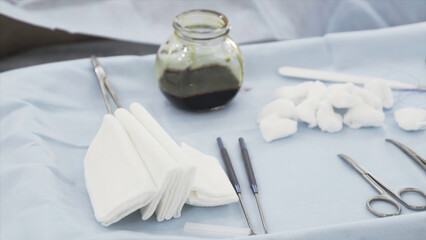Close up of sterile surgical tools for the surgery. Action. Hand of a medical doctor in protective...