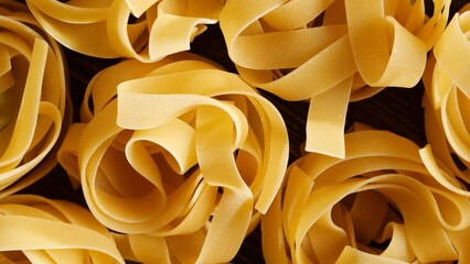 Close up of raw italian nest shaped pasta on rotating table. 4k footage