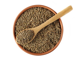 Anise seeds spice (Pimpinella anisum) in clay pot and wooden spoon isolated on white, top view